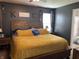Spacious main bedroom featuring dark walls, a wooden bed frame, and ample natural light at 1420 Wigwam Ln, Martinsville, IN 46151