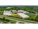 Aerial view of school and grounds showcasing a modern complex near a highway, surrounded by greenery at 14274 Matt St, Carmel, IN 46033