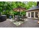 Backyard deck with patio table, grill, and lush greenery, perfect for outdoor dining and entertainment at 14274 Matt St, Carmel, IN 46033
