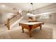 Basement featuring a pool table, stairs, and a bar area at 14274 Matt St, Carmel, IN 46033