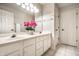 Bathroom features dual sinks and a large mirror with decorative plants and white cabinets at 14274 Matt St, Carmel, IN 46033
