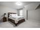 Cozy bedroom features soft carpet, a neutral paint scheme, and ample natural light from the window at 14274 Matt St, Carmel, IN 46033