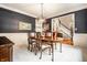 Elegant dining room featuring dark walls, bright trim, and a stylish chandelier at 14274 Matt St, Carmel, IN 46033