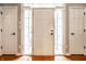 Bright foyer with hardwood floors, white trim, and a front door flanked by windows at 14274 Matt St, Carmel, IN 46033