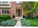 Inviting front entrance with a brick facade, potted flowers, and manicured shrubs at 14274 Matt St, Carmel, IN 46033