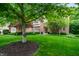 Well-manicured front yard with lush green lawn, mature trees, and a classic brick home at 14274 Matt St, Carmel, IN 46033