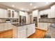 Spacious kitchen features white cabinets, stainless steel appliances, granite countertops, and hardwood floors at 14274 Matt St, Carmel, IN 46033