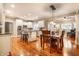 Open-concept kitchen and dining area with hardwood floors, white cabinets, and stainless steel appliances at 14274 Matt St, Carmel, IN 46033