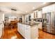 Open kitchen showcases a granite island, stainless appliances, and seamless flow into the adjacent dining area at 14274 Matt St, Carmel, IN 46033