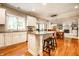 Bright kitchen with granite island, hardwood floors, and views into the dining area and living spaces at 14274 Matt St, Carmel, IN 46033