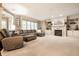 Spacious living room with a fireplace, built-in shelving, and large windows that provide ample natural light at 14274 Matt St, Carmel, IN 46033