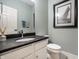 Clean powder room with white vanity and dark granite countertop at 14274 Matt St, Carmel, IN 46033