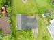 Overhead shot of the property highlights the roof, driveway, large backyard, and mature trees at 1440 Fenwick Ave, Indianapolis, IN 46219