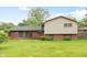 Well-maintained backyard features a combination of brick and siding exterior with lush green grass at 1440 Fenwick Ave, Indianapolis, IN 46219