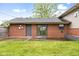 Brick home's rear exterior with well-maintained lawn and patio area at 1440 Fenwick Ave, Indianapolis, IN 46219