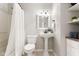 Bathroom featuring a white pedestal sink, neutral walls, tiled floors, and a shower with a white curtain at 1440 Fenwick Ave, Indianapolis, IN 46219