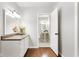 Bathroom with hardwood floors, white cabinets, and a view to another bathroom at 1440 Fenwick Ave, Indianapolis, IN 46219