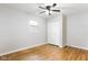 Bedroom with hardwood floors, neutral walls, a ceiling fan, a window and closet with bi-fold doors at 1440 Fenwick Ave, Indianapolis, IN 46219