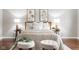 Bedroom with hardwood floors, lamps, and neutral decor at 1440 Fenwick Ave, Indianapolis, IN 46219