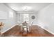 Bright dining area with hardwood floors, modern lighting, and a view through French doors at 1440 Fenwick Ave, Indianapolis, IN 46219