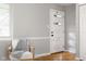 Bright entryway featuring a modern door with glass accents, a comfortable chair, and hardwood floors at 1440 Fenwick Ave, Indianapolis, IN 46219