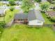 Overhead view of a two-story home showcasing the backyard and landscaping with a wooden fence at 1440 Fenwick Ave, Indianapolis, IN 46219