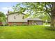 Charming two-story home featuring a well-manicured lawn, brick accents, and a comfortable front porch seating area at 1440 Fenwick Ave, Indianapolis, IN 46219