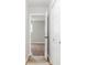 Hallway with neutral walls leads to a bedroom with hardwood flooring and a view of the outside at 1440 Fenwick Ave, Indianapolis, IN 46219
