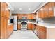 Well-lit kitchen with tile floors, stainless steel appliances, and ample cabinet space at 1440 Fenwick Ave, Indianapolis, IN 46219