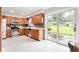 Bright kitchen features stainless steel appliances, tile flooring, and sliding glass door to the backyard at 1440 Fenwick Ave, Indianapolis, IN 46219