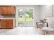Bright eat-in kitchen featuring sliding glass doors to the backyard and wood cabinets at 1440 Fenwick Ave, Indianapolis, IN 46219
