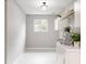 Bright laundry room with modern appliances, white cabinets, and sleek countertop at 1440 Fenwick Ave, Indianapolis, IN 46219