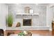 Cozy living room featuring a white brick fireplace with decorative mantle and hardwood floors at 1440 Fenwick Ave, Indianapolis, IN 46219