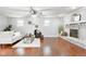 Spacious living room with hardwood floors, neutral walls, modern decor, and a cozy seating area by the fireplace at 1440 Fenwick Ave, Indianapolis, IN 46219