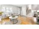 Open-concept living room featuring hardwood floors, neutral paint, plenty of sunlight, and comfortable seating at 1440 Fenwick Ave, Indianapolis, IN 46219