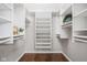 Bright and spacious walk-in closet with custom white shelving, ample storage and wood floor at 1440 Fenwick Ave, Indianapolis, IN 46219