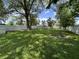 A spacious backyard surrounded by a white fence and mature trees at 1440 Sycamore St, Columbus, IN 47201
