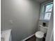 A clean half bathroom with a modern toilet, vanity, and natural light at 1440 Sycamore St, Columbus, IN 47201