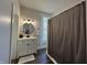 Full bathroom with a vanity, round mirror, vanity lighting, and shower with a curtain at 1440 Sycamore St, Columbus, IN 47201
