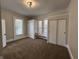 Spacious bedroom featuring carpet, windows, and a closet for ample storage at 1440 Sycamore St, Columbus, IN 47201