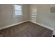 Neutral bedroom featuring a window, brown carpet, and built-in shelving at 1440 Sycamore St, Columbus, IN 47201