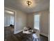 Well-lit dining area with seating for two, contemporary light fixture, and an open doorway at 1440 Sycamore St, Columbus, IN 47201