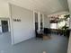 Covered front porch with cozy seating area provides a welcoming entrance at 1440 Sycamore St, Columbus, IN 47201
