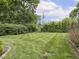 Grassy backyard with well-maintained lawn and mature tree border at 150 E 46Th St, Indianapolis, IN 46205