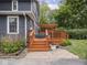 A backyard features a wooden deck, plants, and a stone pathway, creating an inviting outdoor space at 150 E 46Th St, Indianapolis, IN 46205