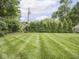 Spacious backyard with lush green lawn and mature trees, providing a private and serene outdoor retreat at 150 E 46Th St, Indianapolis, IN 46205