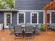 Backyard deck with wooden pergola, string lights, comfortable seating, and dining area for outdoor relaxation at 150 E 46Th St, Indianapolis, IN 46205