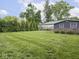 Spacious backyard featuring lush green grass and well-maintained landscaping at 150 E 46Th St, Indianapolis, IN 46205