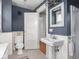 This bathroom features a classic pedestal sink, toilet and a shower with tiled floors, providing comfort and style at 150 E 46Th St, Indianapolis, IN 46205