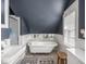 Elegant bathroom featuring a clawfoot tub, stylish fixtures, and natural light, offering a serene and luxurious bathing experience at 150 E 46Th St, Indianapolis, IN 46205
